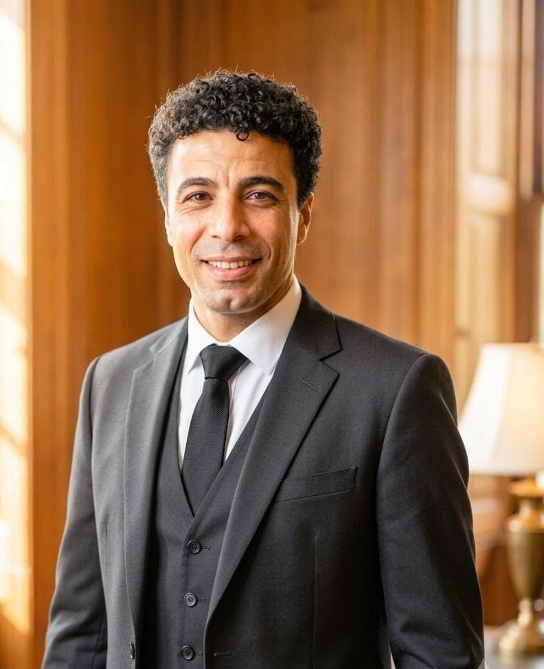 Mazen Nafady, Company Director of The Godfather Group, in a charcoal three-piece suit in a wood-panelled office